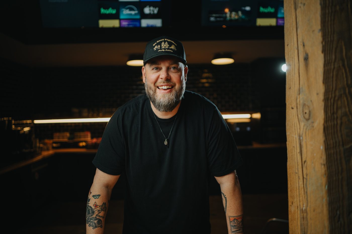 Drew Powell, owner of Blue Collar Digital, smiling in a trucker hat